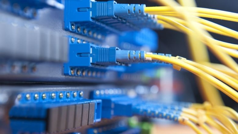 cra-data-security Roughly a dozen brightly coloured computer cables connect to a panel.