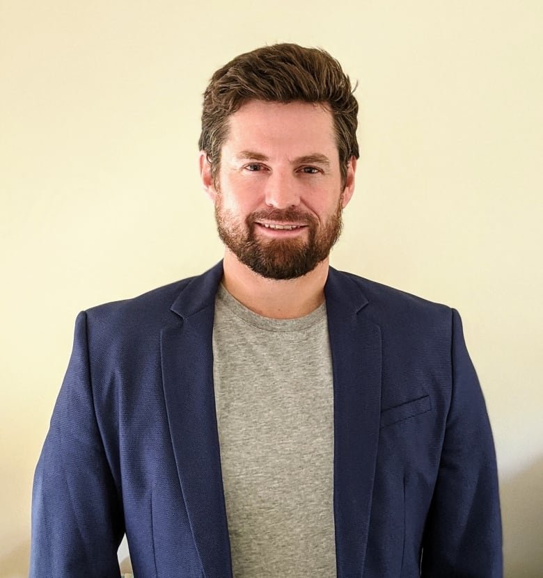 graeme-moffatt Portrait of a smiling bearded man in a blue suit jacket