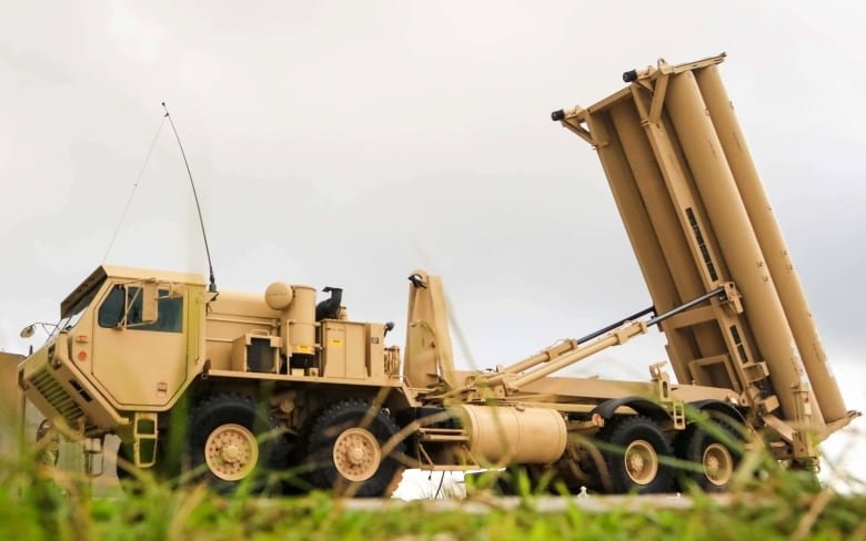 A missile launcher mounted on a large truck is angled upward, as if about to fire.