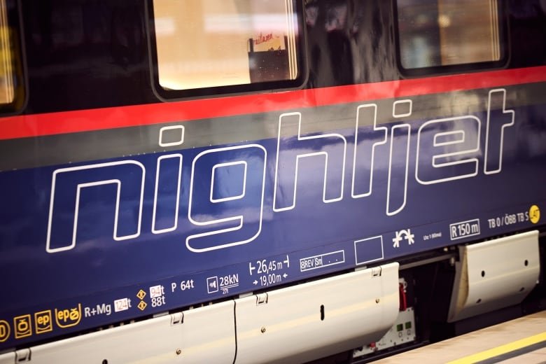 The side of a rail car, with the word 'NightJet' written on it.