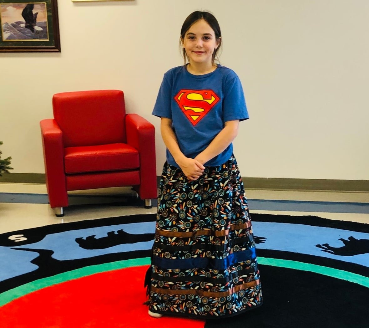 colleen-silverthorn A young girl poses wearing a ribbon skirt.