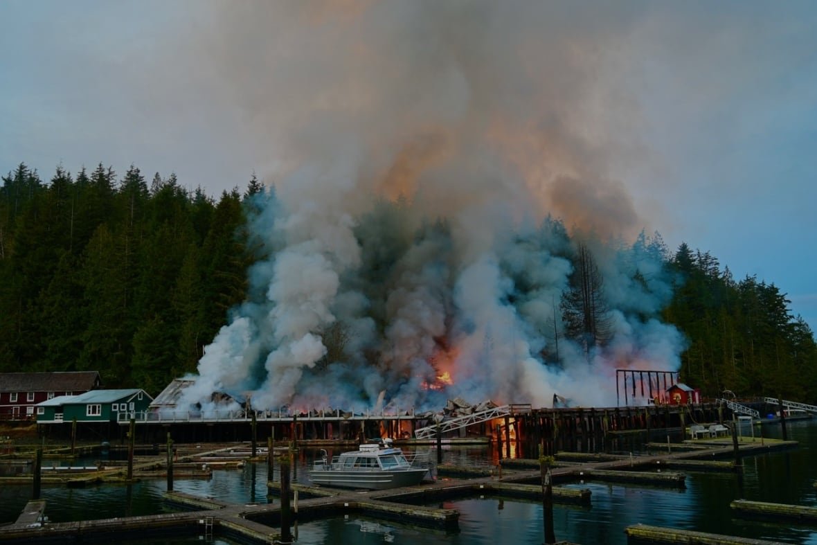 telegraph-cove-fire Smoke and flames rise from a boardwalk.