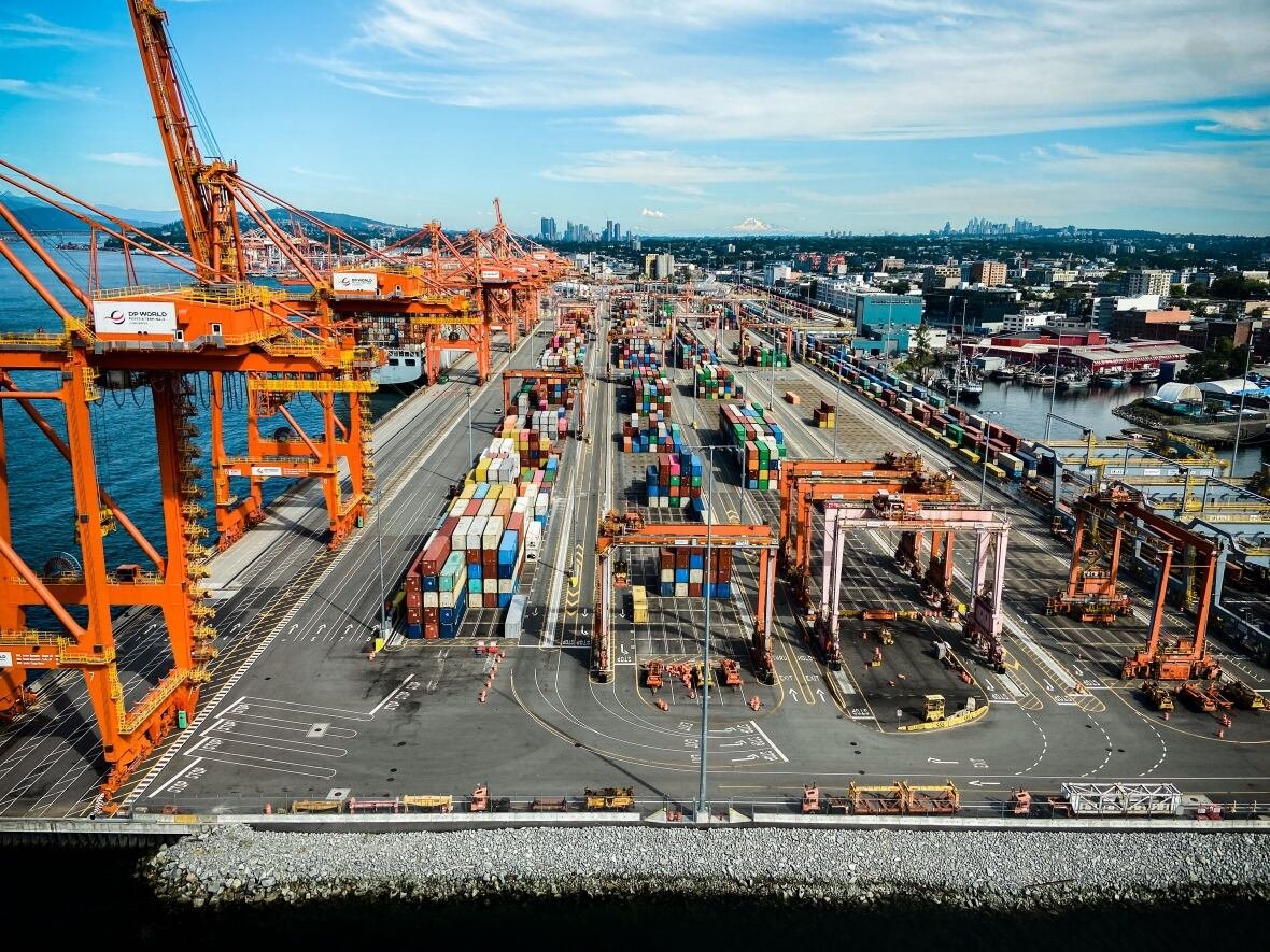 aerial-view-of-the-port-of-vancouver-stock-generic-file-drone A large port, with cargo containers seen next to large cranes on a sunny day.