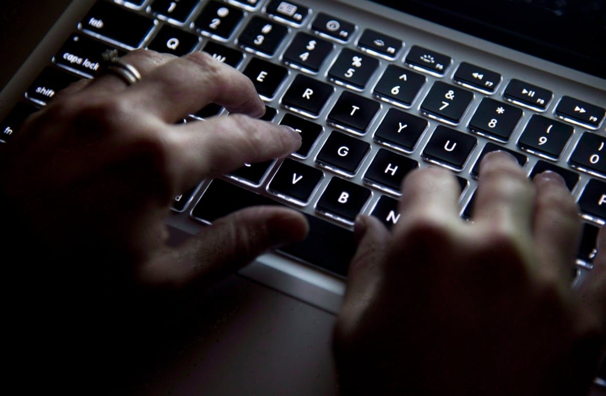 ont-nurses-cybersecurity-20200918 A woman's hands using her computer keyboard to type
