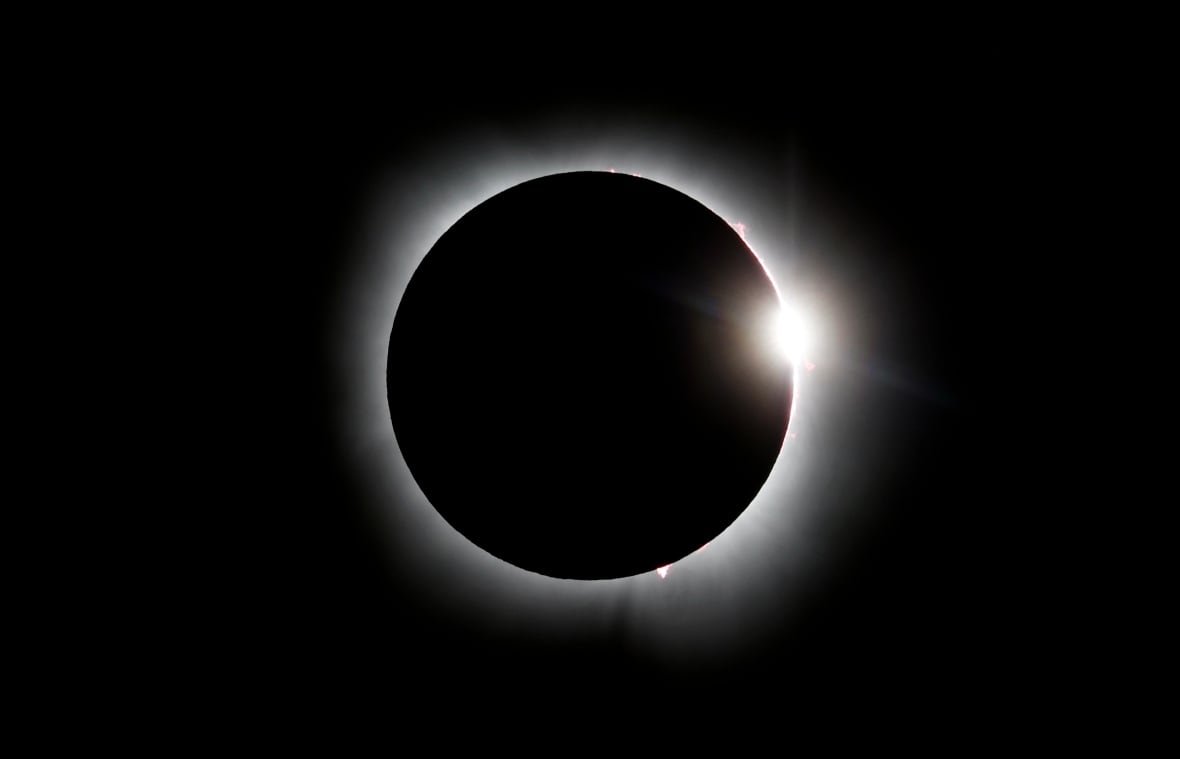 2147663274 The eclipsed sun, looking like a ring of light against a dark sky.