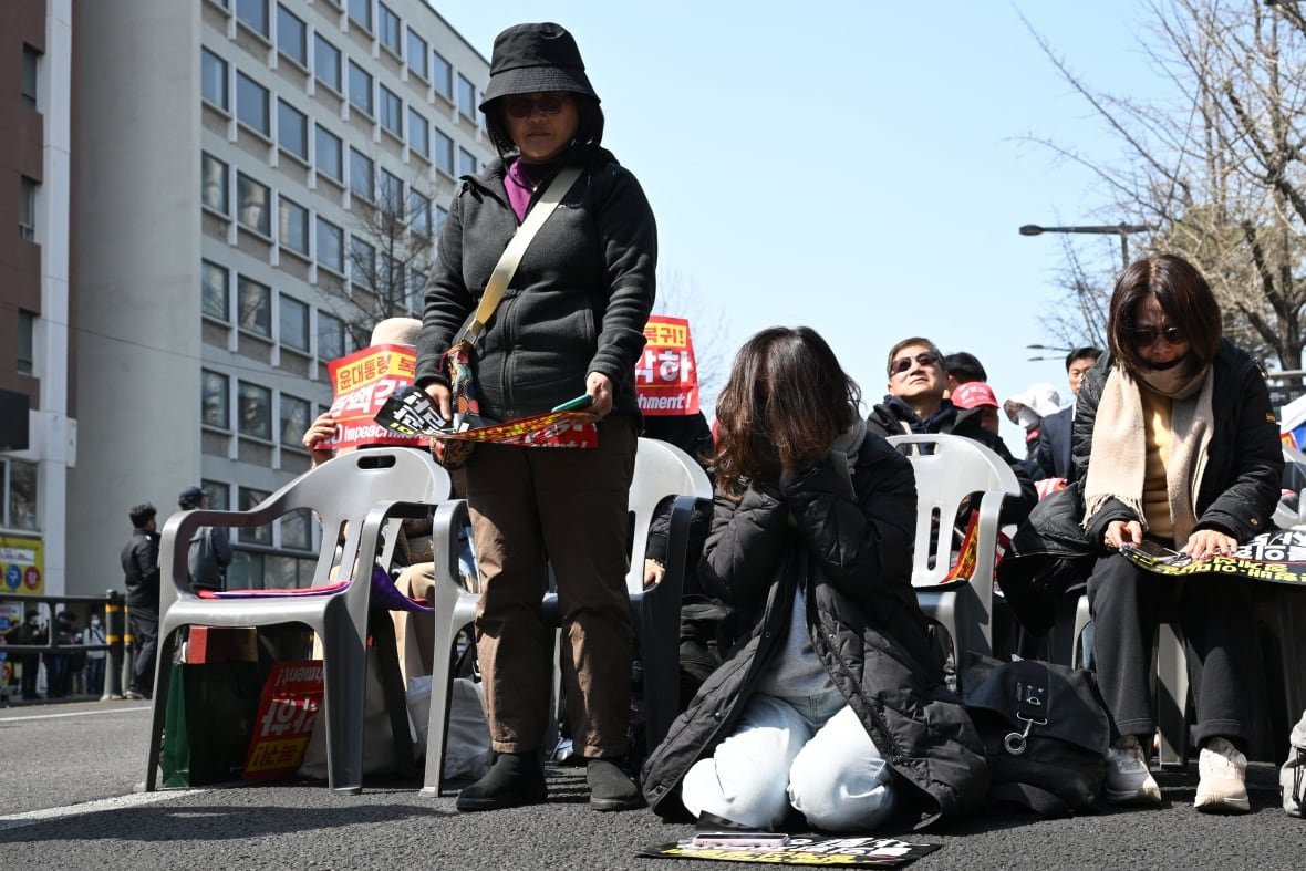 2207772377 Demonstrators react negatively during a public rally.