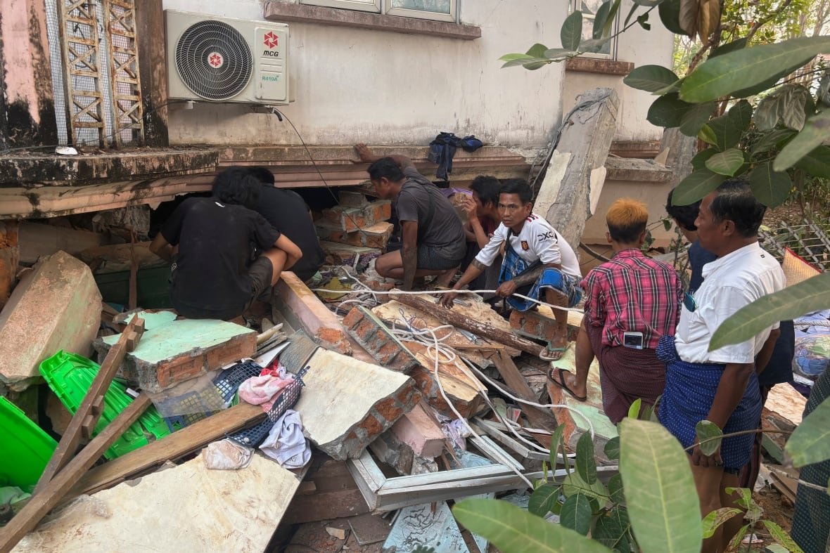 aptopix-myanmar-earthquake People look under a collapsed building.