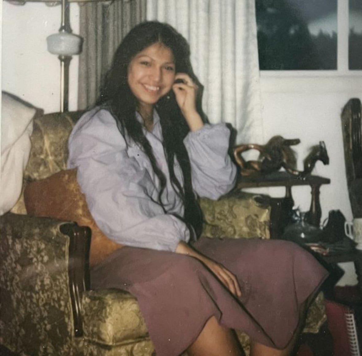 belinda-cameron-1 An Indigenous woman with long black hair smiles at a camera.