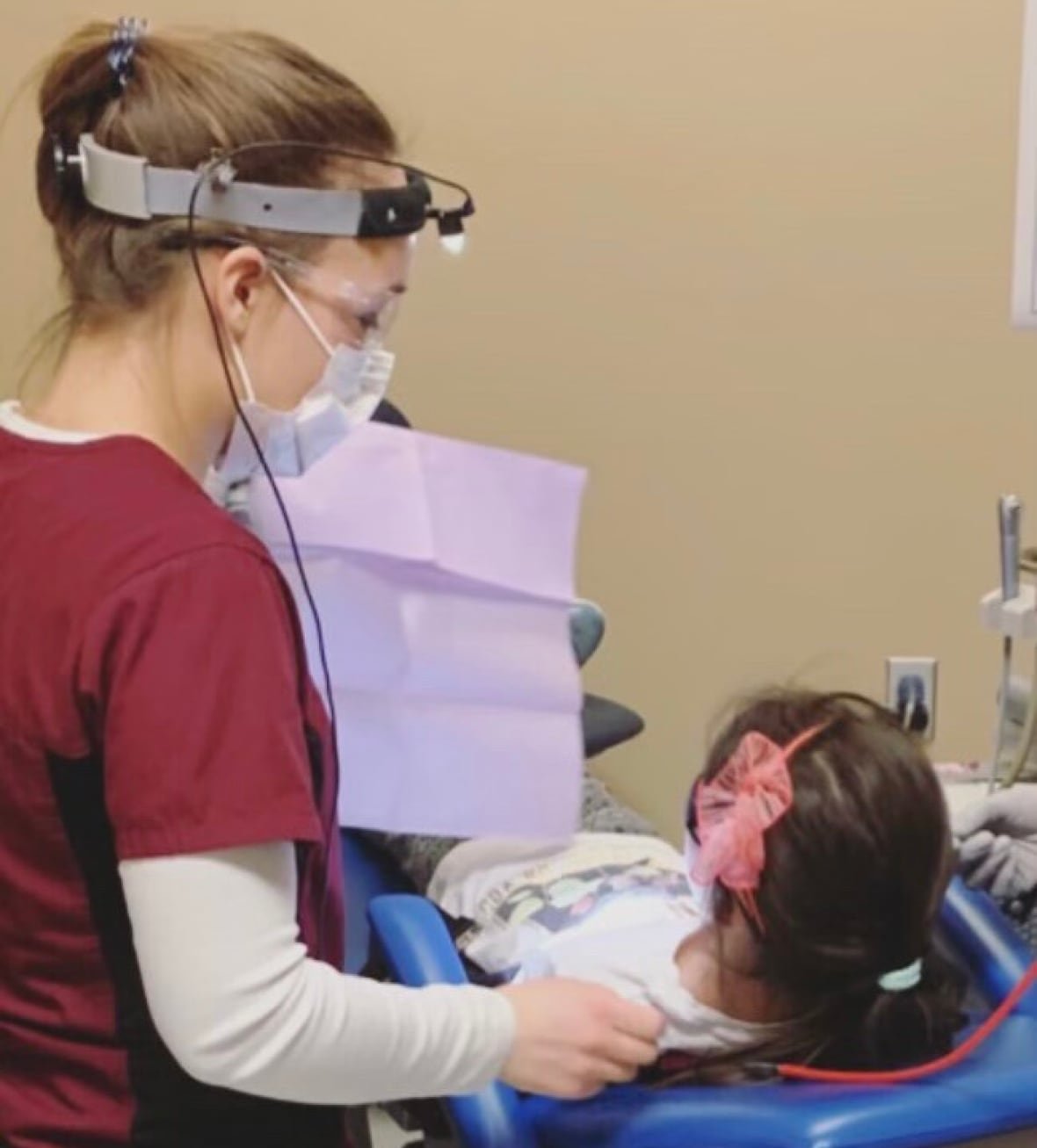 camille-poirier-3 A woman cleaning a child's teeth.