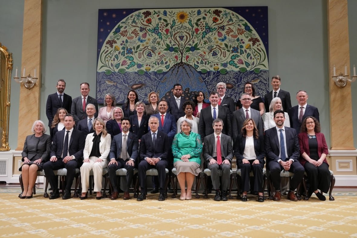carney-cabinet-shuffle-gallery-27 A group of people sit together for a photo.