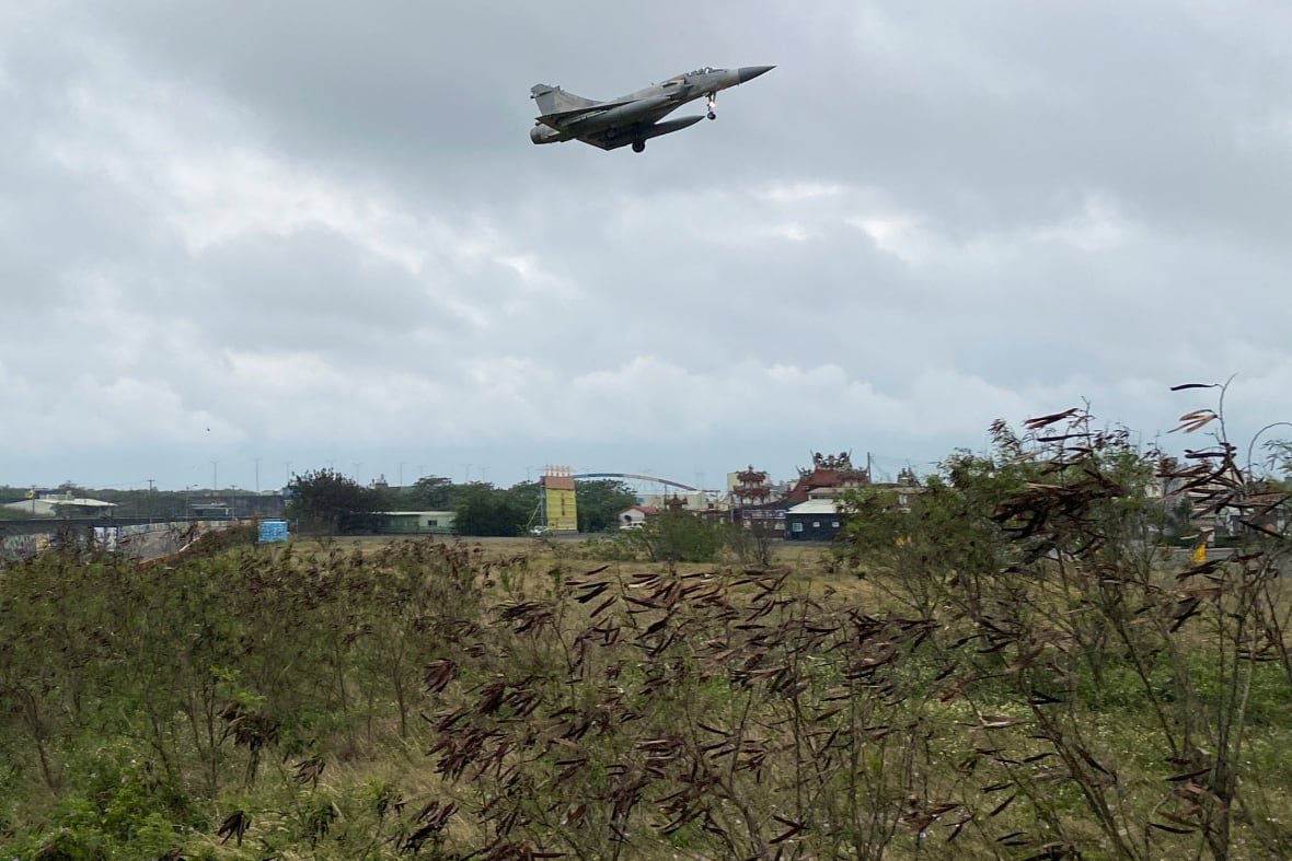 china-taiwan-military A military jet hovers over a grassy field