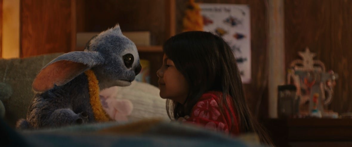 ent-film-review-lilo-stitch-1 A little girl and blue alien look at one another.