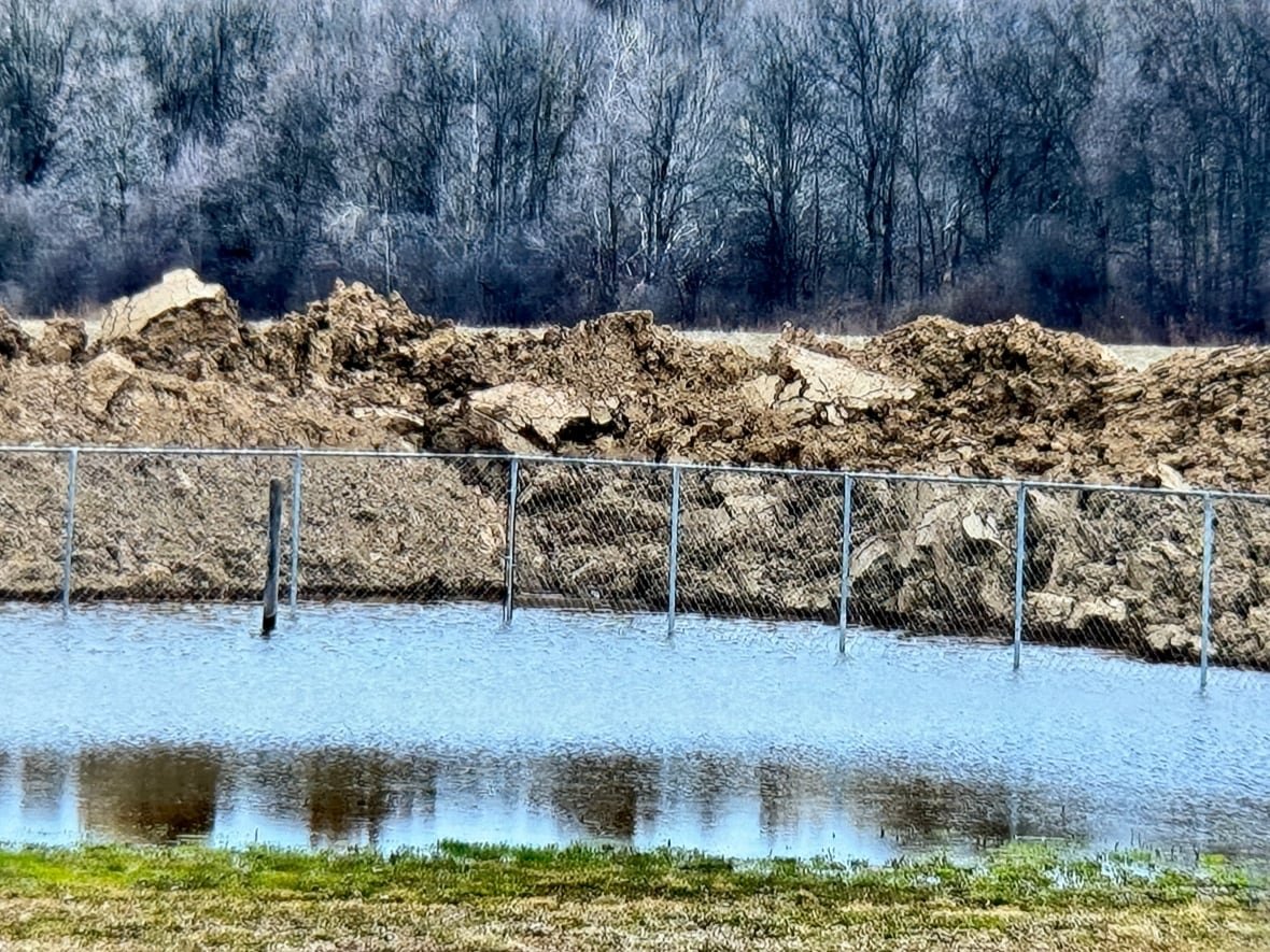 flooding Flood damage to property which shows several feet of water nearly reaching the septic tile bed.