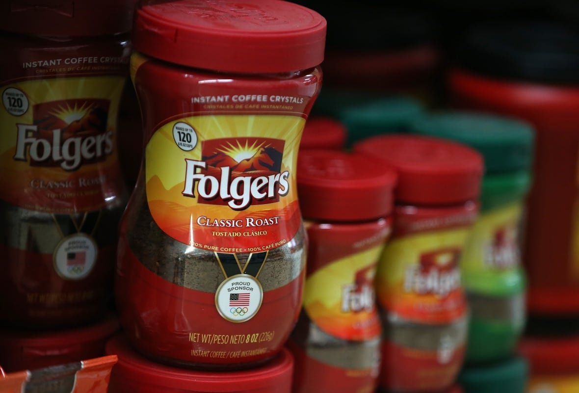 folgers Packages of Folgers coffee are displayed on a shelf at a grocery store