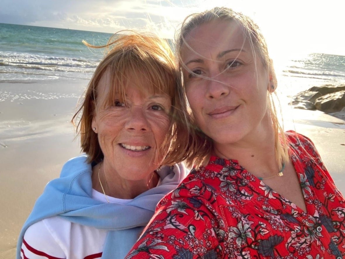 gisele-pelicot-and-caroline-darian Two women posing for a selfie on a beach.