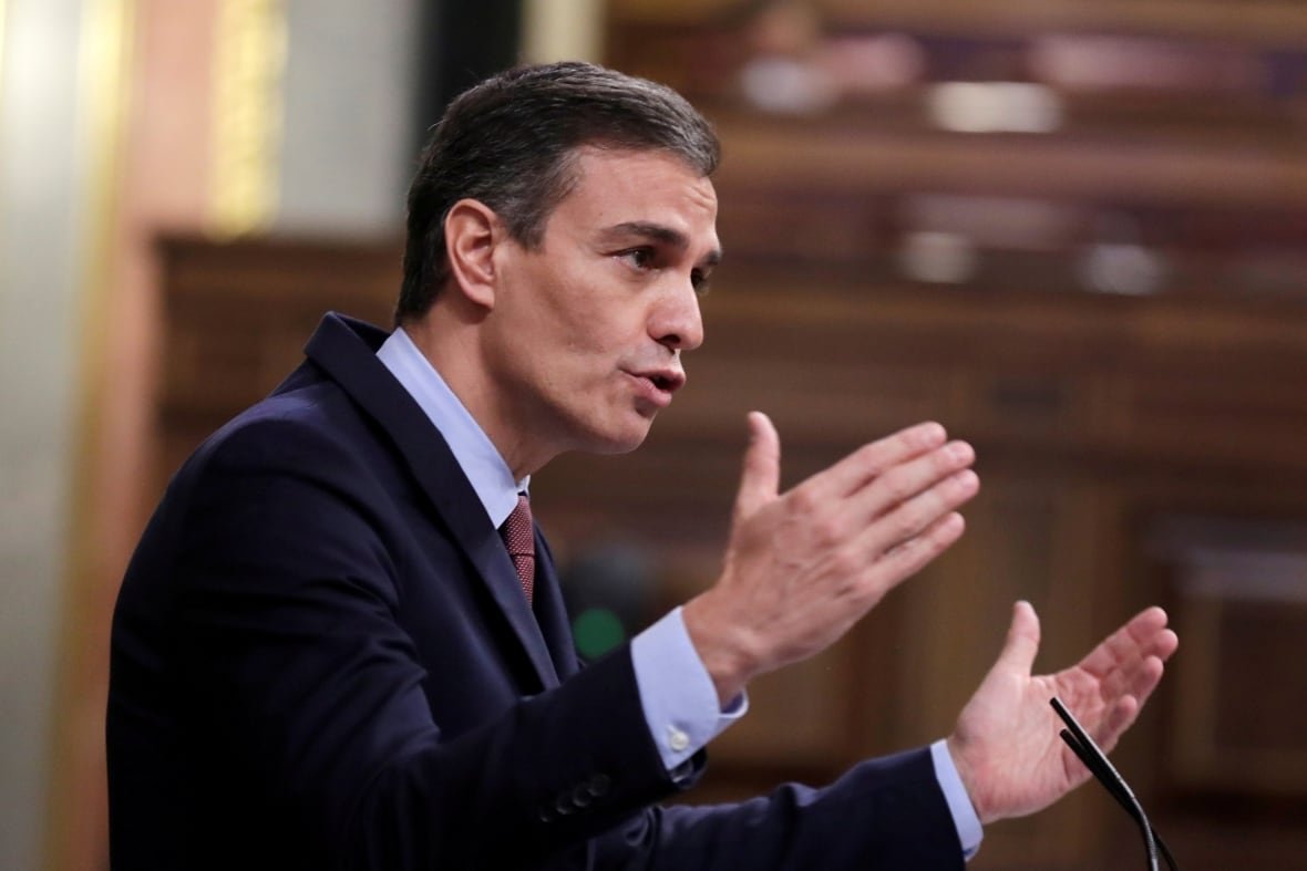 health-coronavirus-spain A man in a suit gestures with his hands