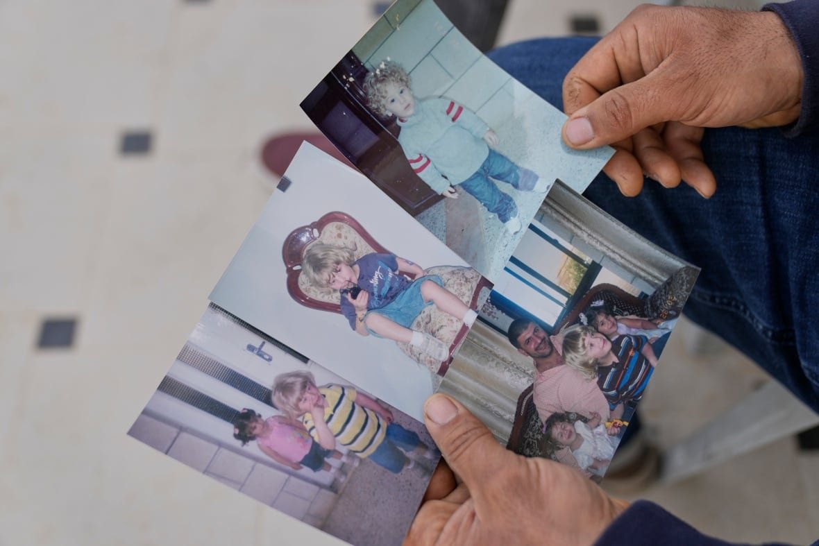 israel-palestinians-teenage-prisoner-dies-1 A man holds childhood photos of his son.