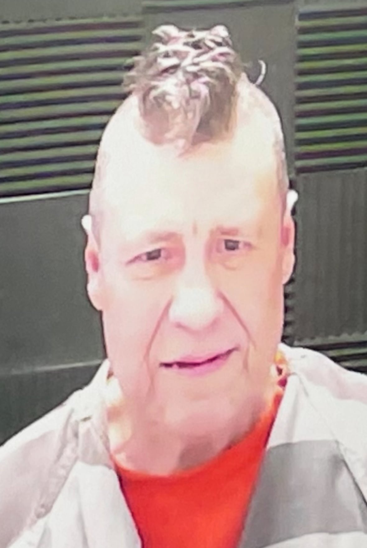 james-mast A man with a Mohawk and striped prison shirt.