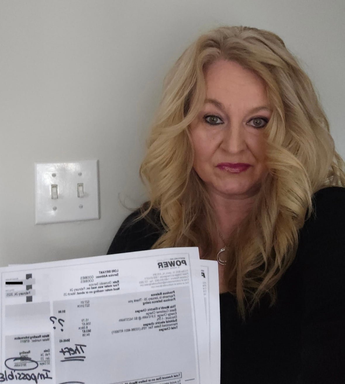 lori-ann-bryant-1 A woman holding up her bill