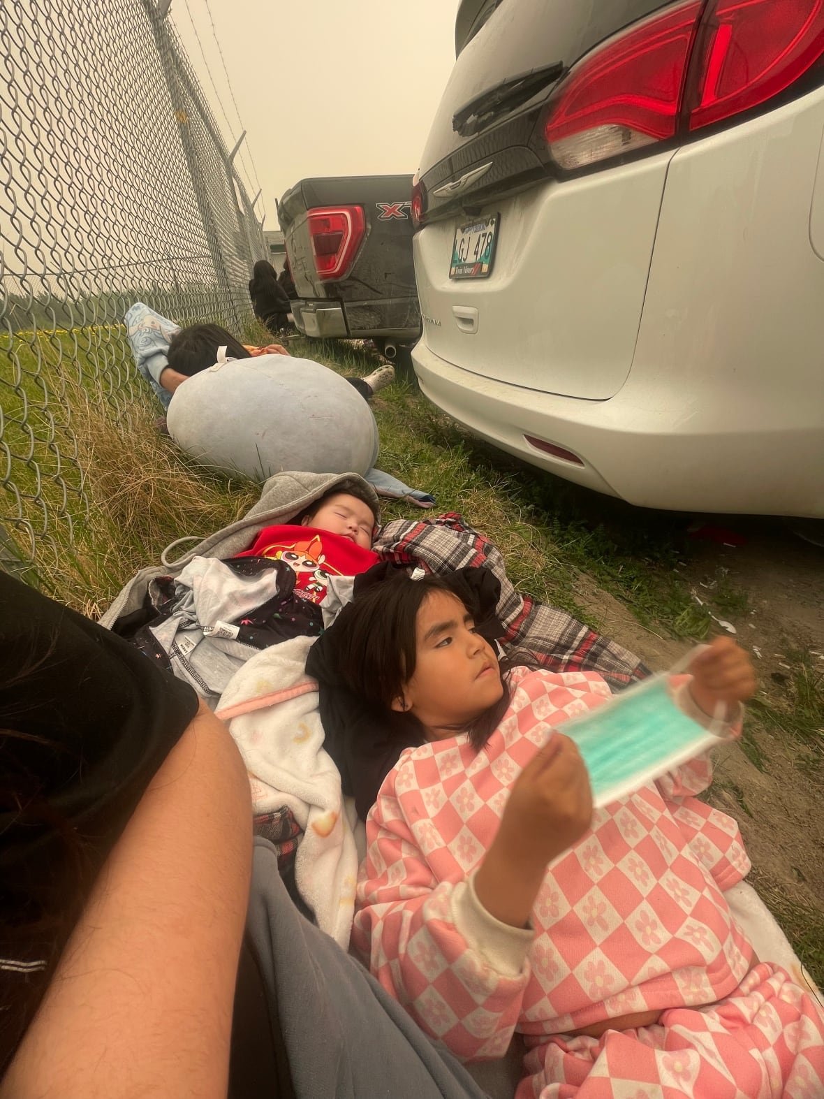 Young girl and baby resting outdoors