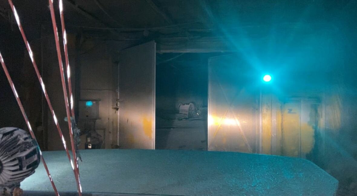 mine-doors-act-like-airlocks-underground-in-picadilly-mine Image of a heavy door opening to allow the mining truck to drive through. The door protects the air pressure and the air ventilation system.