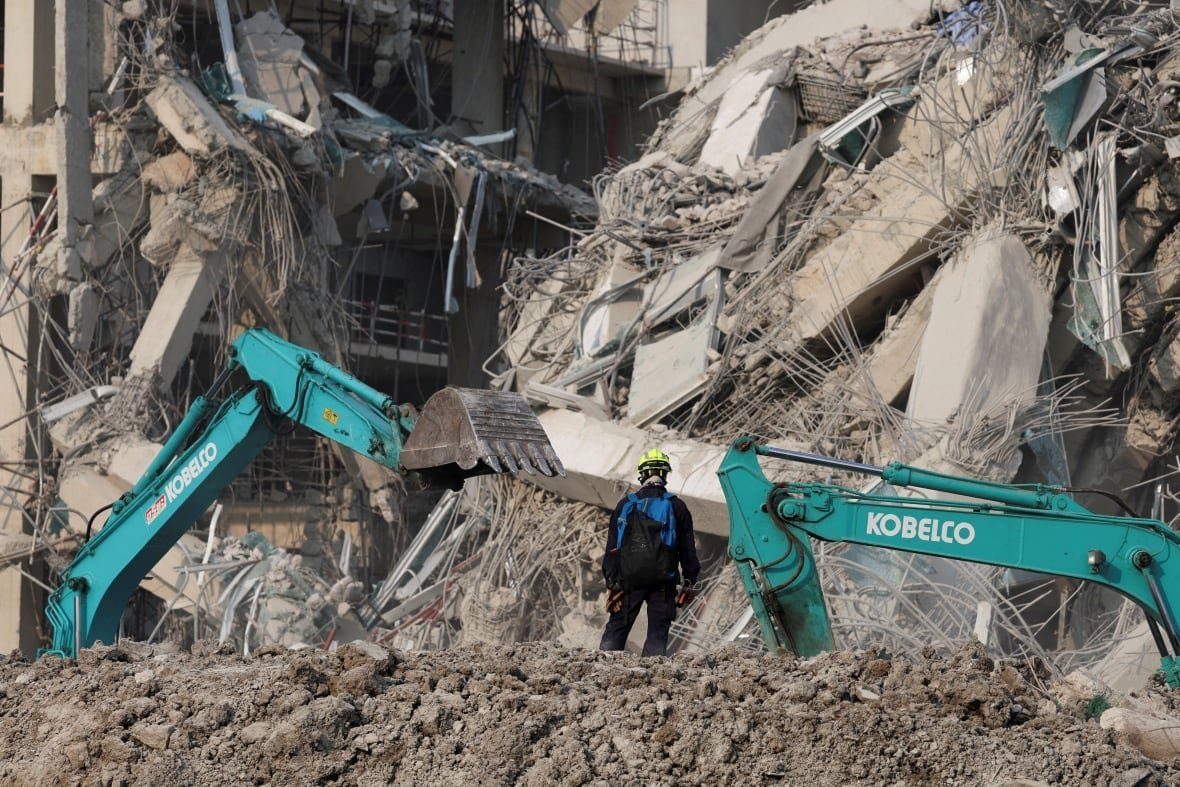 myanmar-quake-thailand-1 A rescuer works at the site of a building that collapsed.