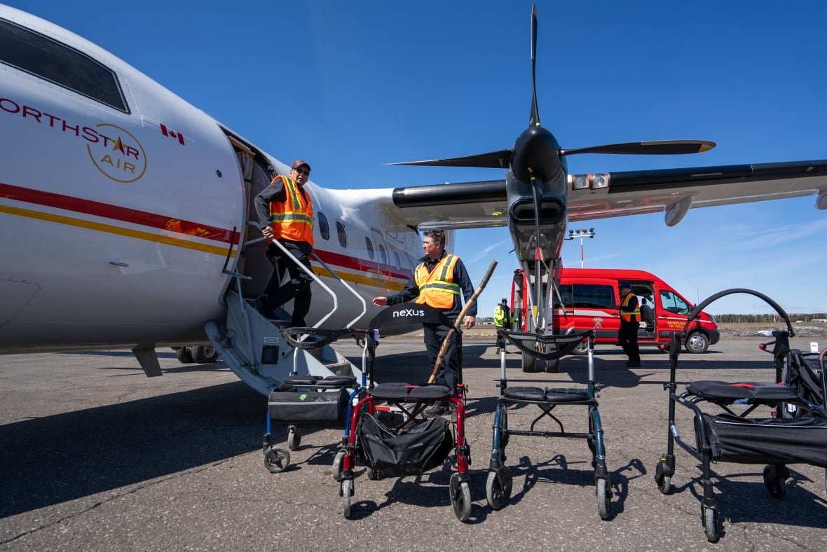 People are seen getting off a plane.