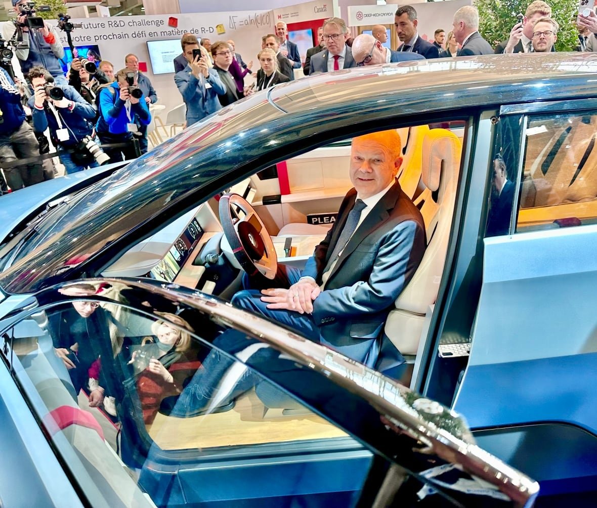 Olaf Scholz, the outgoing German Chancellor sits in a prototype electric car made of all Canadian components. The car, dubbed Project Arrow, contains components of more than 50 Canadian supplies.