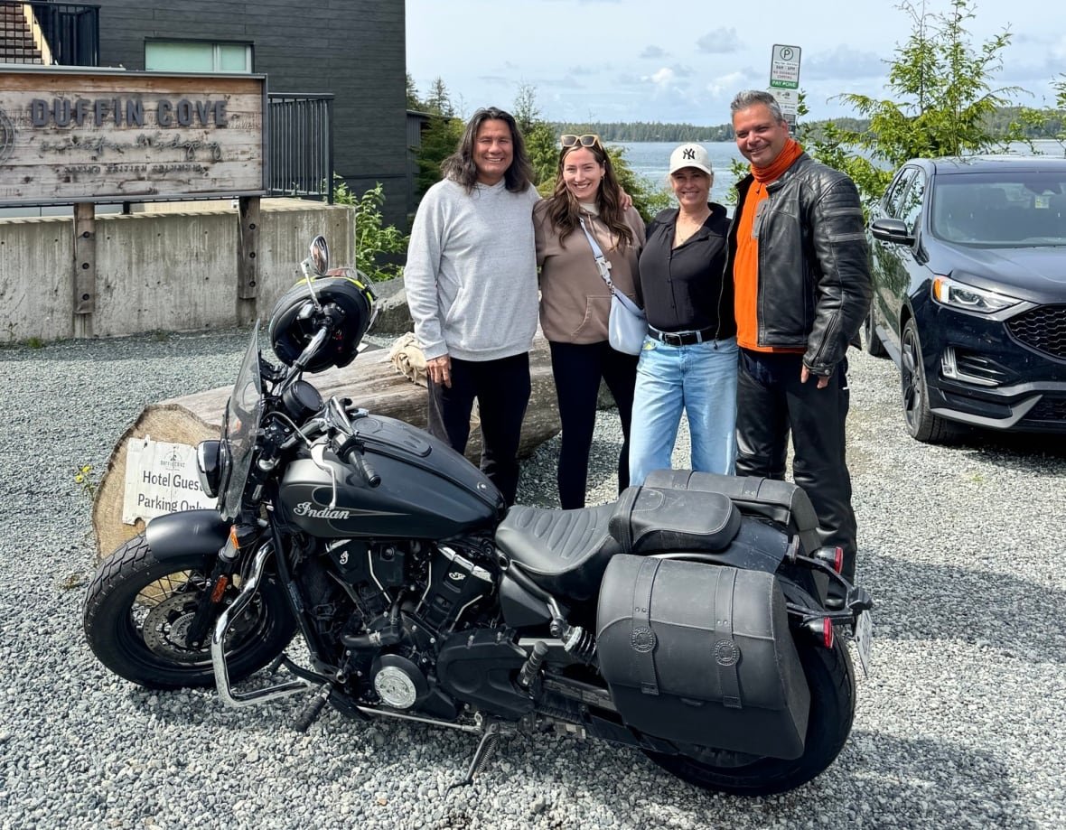pj-murdoch-and-family A family stand behind a motorcycle