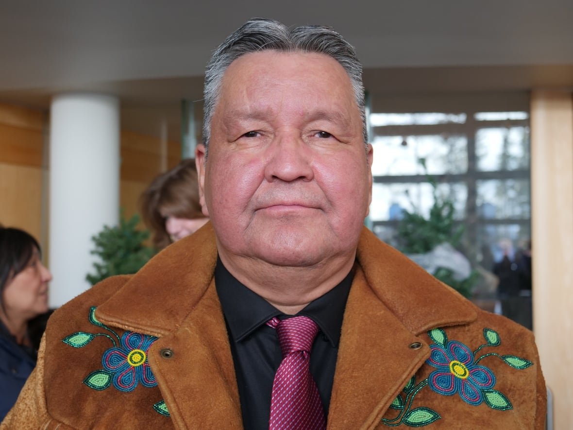 richard-edjericon-1 A portrait of a man in a beaded jacket.