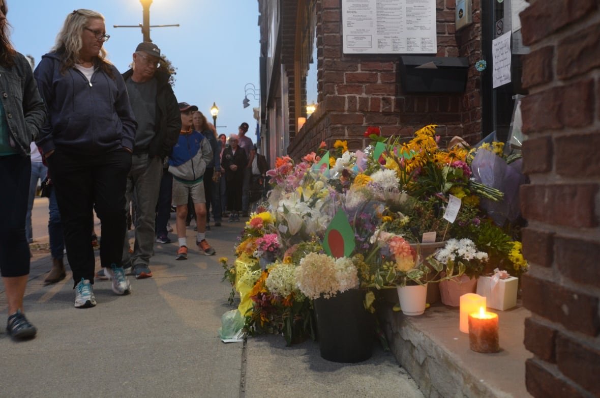 sharif-rahman-vigil People in Owen Sound pass in front of Sharif Rahman's restaurant Sunday Aug. 28, 2023 following his funeral. Rahman was beaten and later died inside the Curry House.