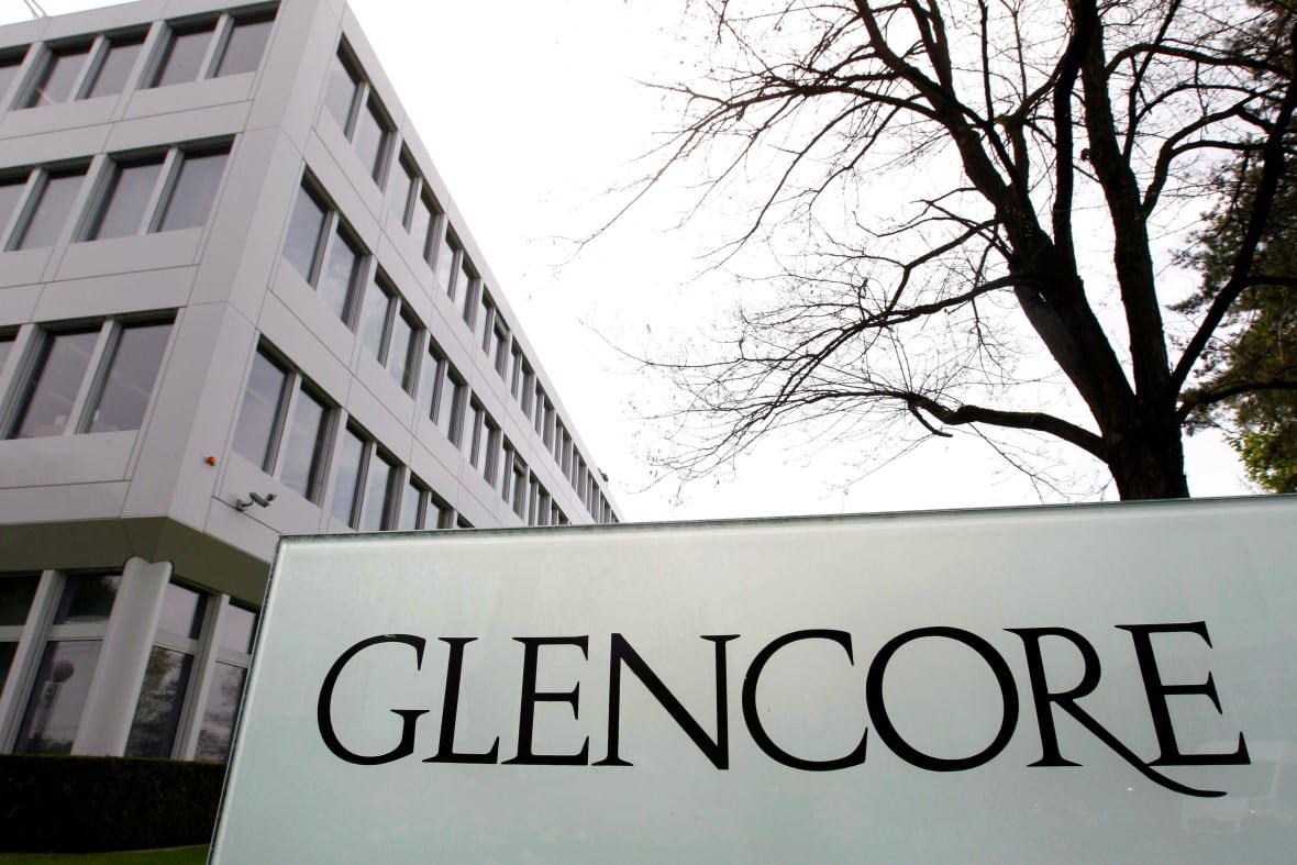 switzerland-glencore A sign written the word 'Glencore' stands next to a building.