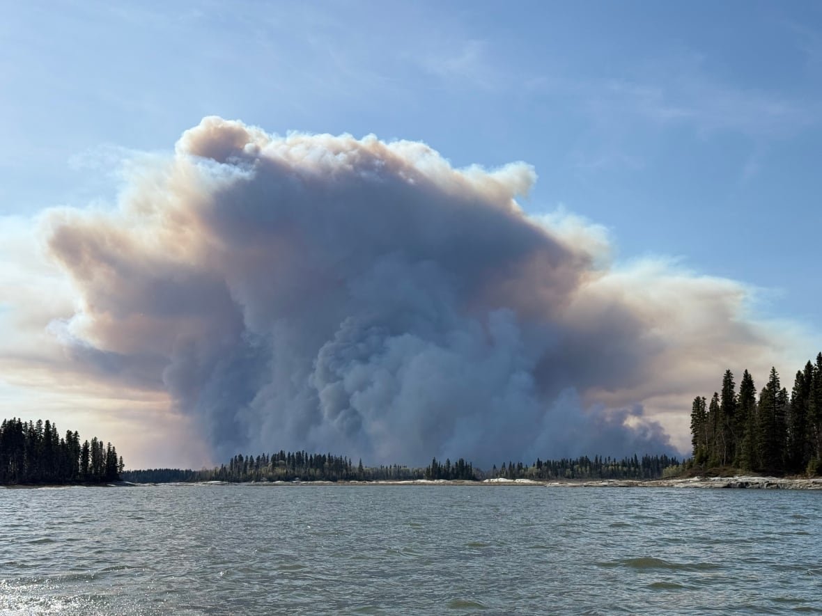 wildfires-near-pimicikamak-cree-nation A plume of smoke billows from behind a lake in Pimicikamak Cree Nation.
