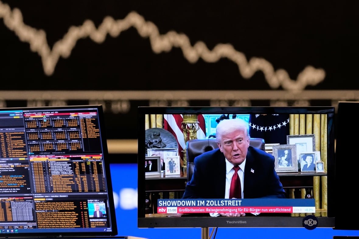 aptopix-germany-stock-market-1 A TV monitor shows a person speaking at a desk as other monitors show financial data.