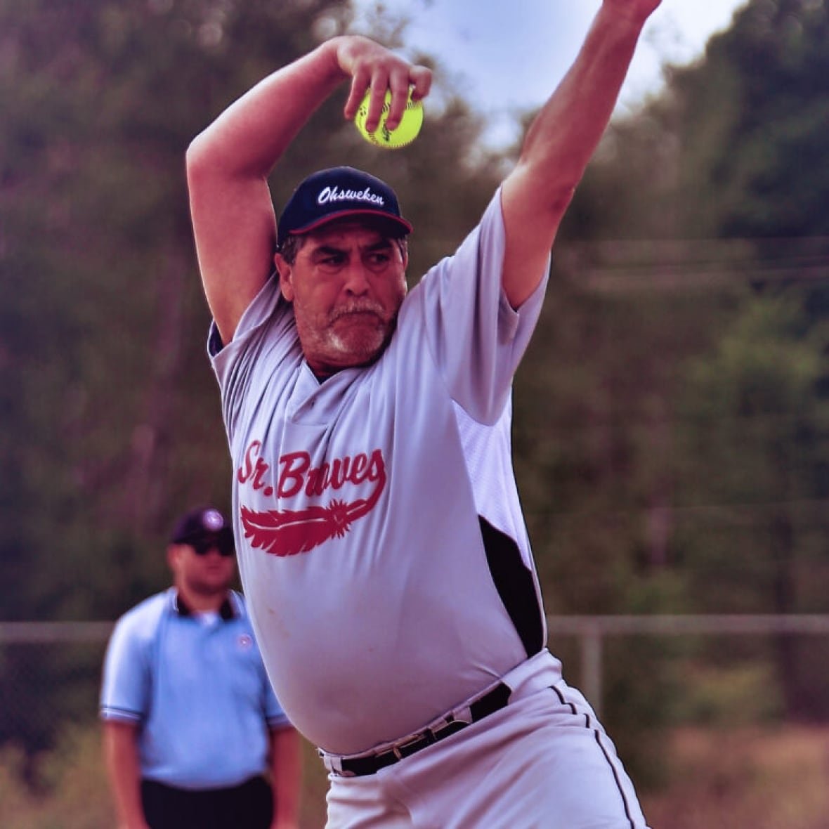 A man playing fastball.