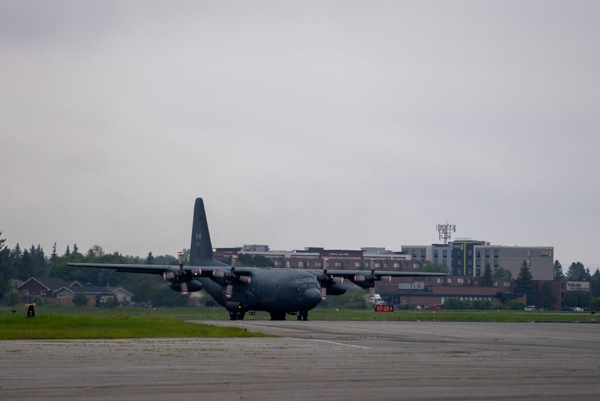 hercules-aircraft A large airplane at an airport.
