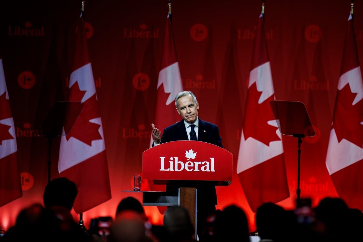 lpc25-new-leader A person gestures while speaking at a lectern to an audience.