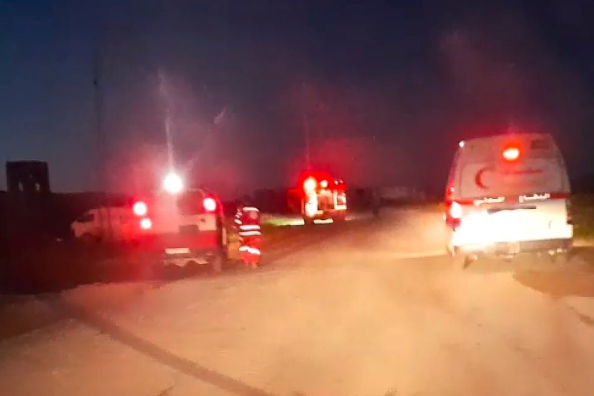 mideast-wars-medics-killed-1 A screengrab from a video shows emergency workers and vehicles on a road.