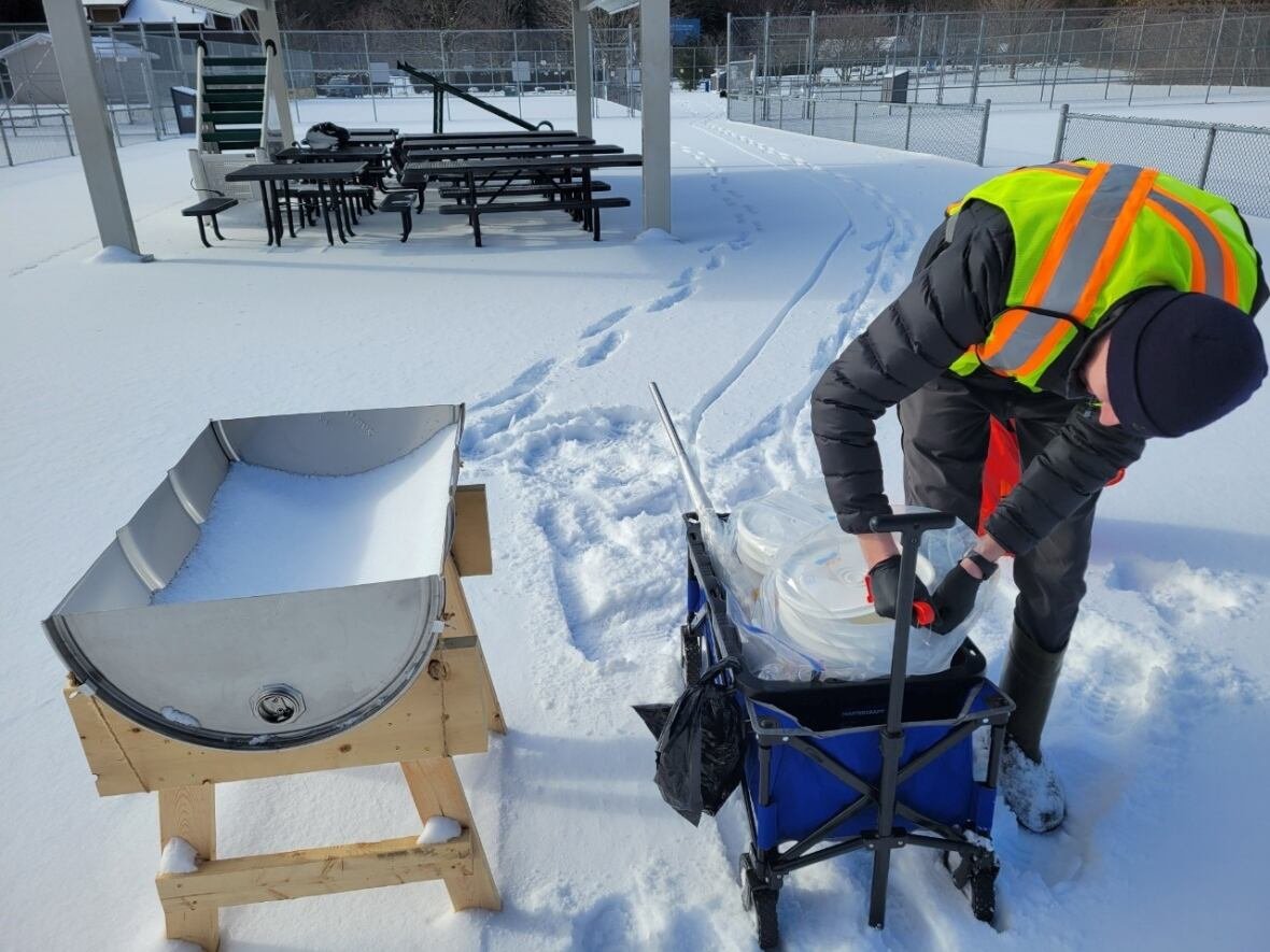 Jonathan Paynter with Environment and Climate Change Canada collects snow samples containing air particles from High Park during the 2024 study, which relied on collection stations spread across the city for a six-week period.