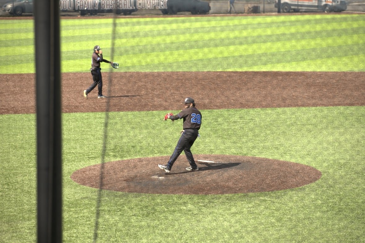 A man throwing a baseball.