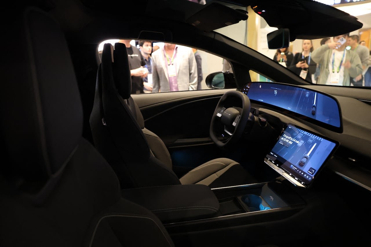 Interior of a vehicle on display during a trade show.