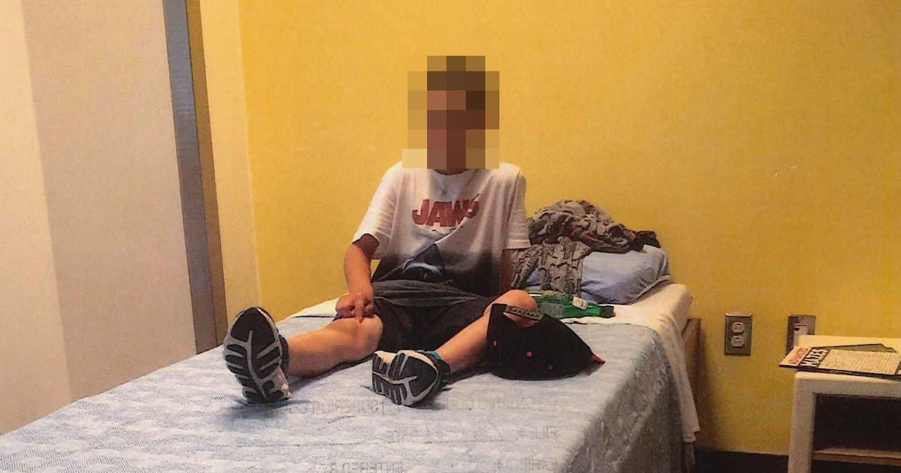 boy sits on bed