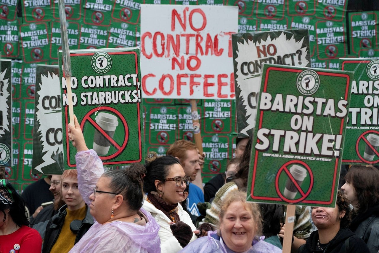 People hold up picket signs.