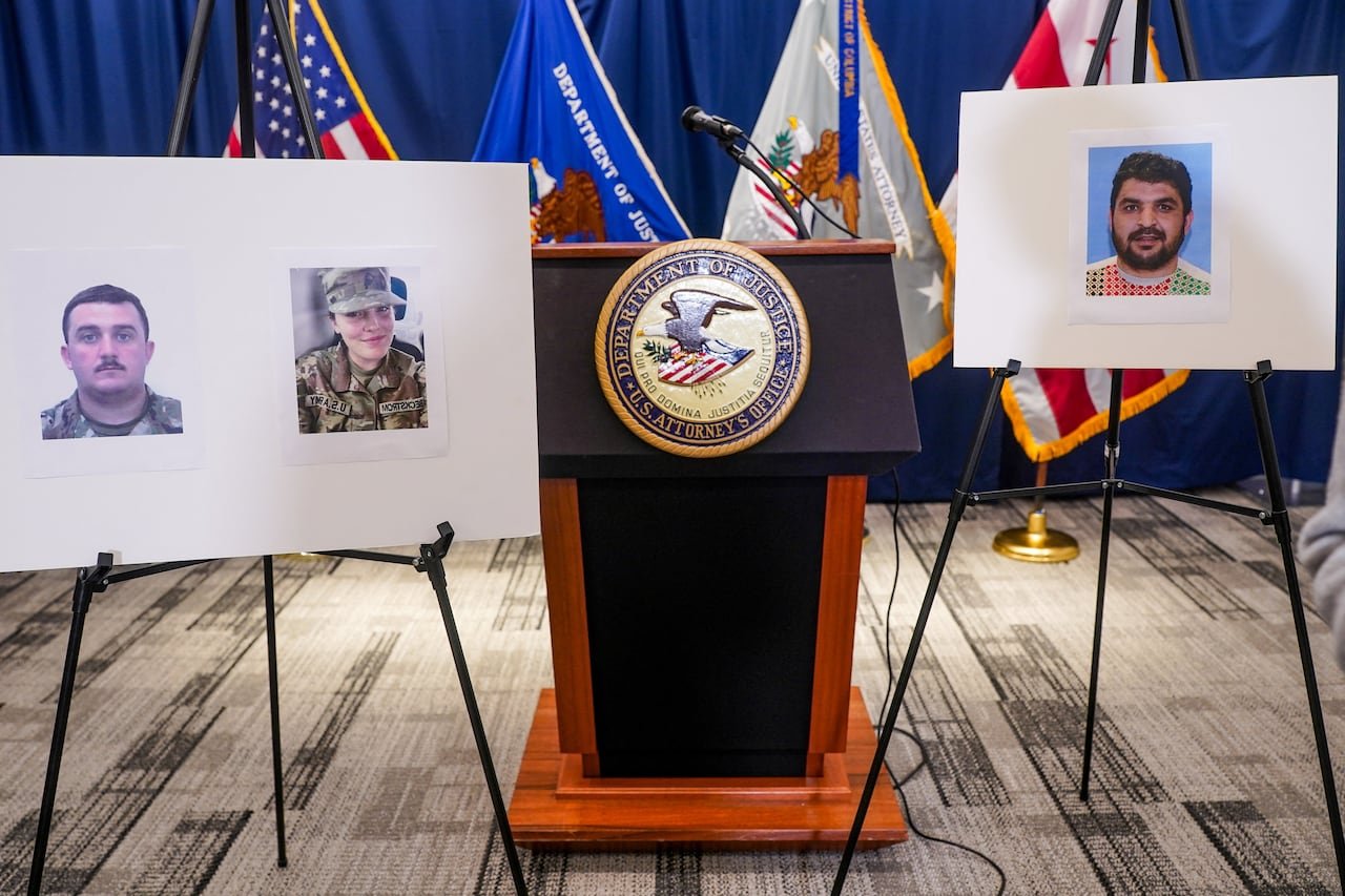 default-274 Placards are shown on easels, depicting two men and a woman. A podium is also shown in a photo absent of people.