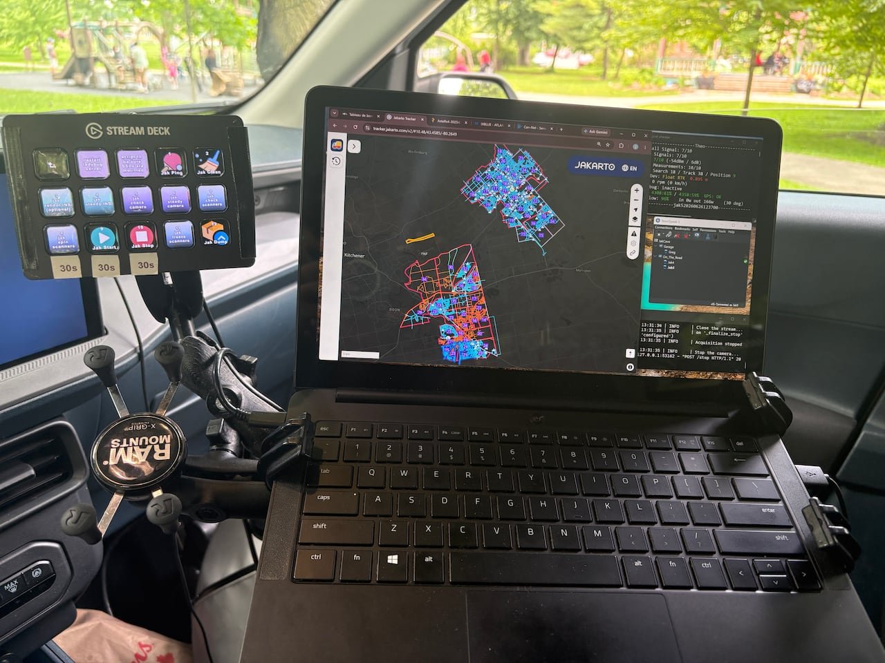 Photo of a computer screen in a car showing maps of cities.